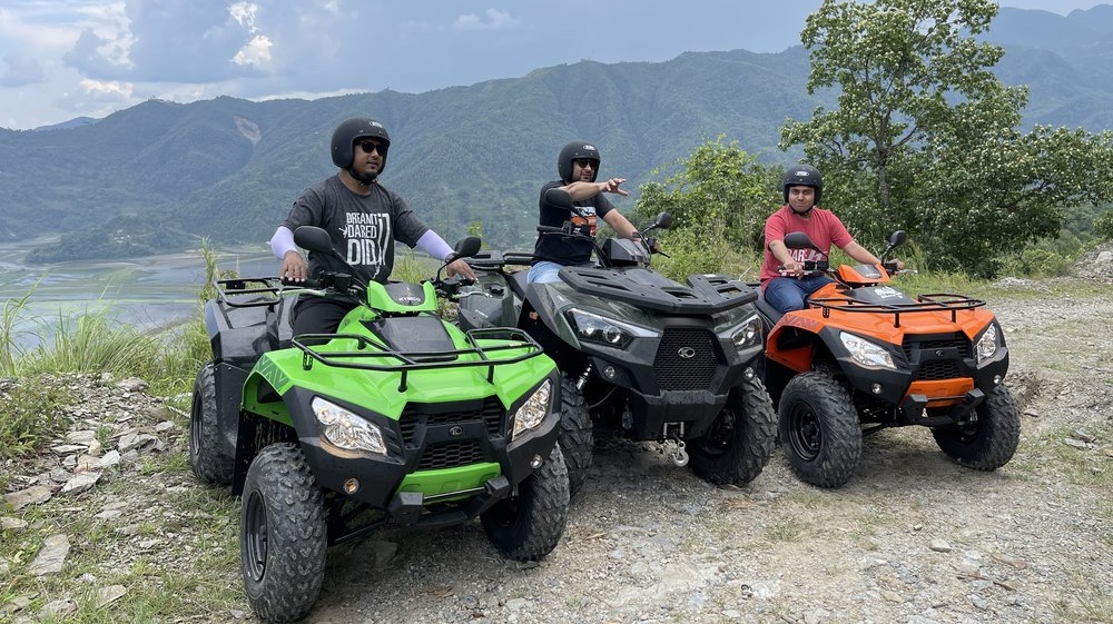 Tourist enjoying ATV ride through rugged trails and hills in Pokhara, Nepal