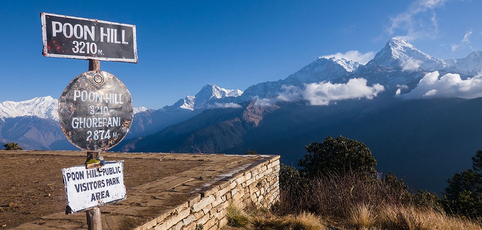 Trekkers enjoying sunrise views of the Annapurna and Dhaulagiri mountain ranges from Poon Hill viewpoint during the Ghorepani trek near Pokhara, Nepal
